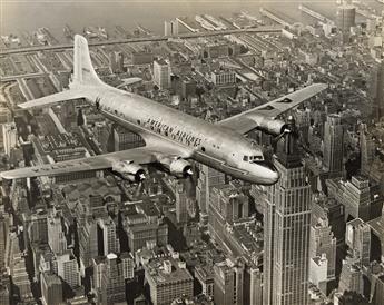 (TAKE FLIGHT OVER MANHATTAN) A collection of approximately 44 photographs of airplanes in flight over New York City. Circa 1930-42.